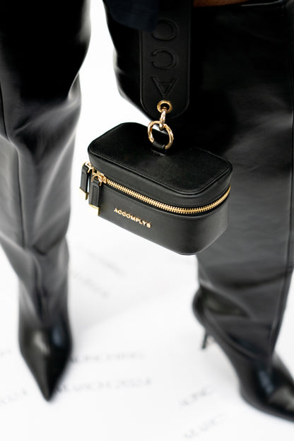 BLACK DROP wristlet with gold lettering.