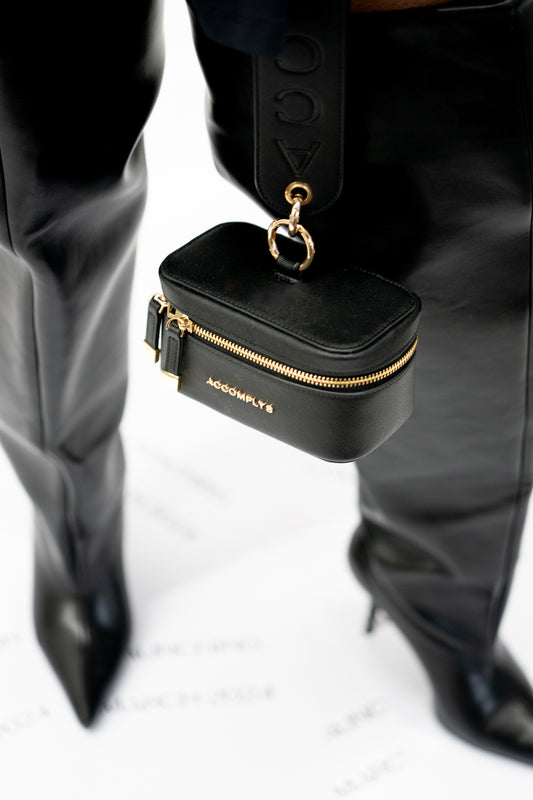 BLACK DROP wristlet with gold lettering.